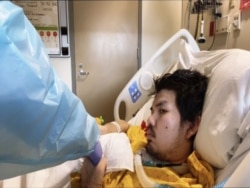 A medical staff member is seen next to Yuttasak Thanawan, "Chef Tang" in the intensive care unit at a hospital in Washington, DC. Dec 2020.