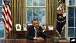 US President Barack Obama talks on the phone in the White House Oval Office (file photo).