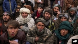 FILE - Hundreds of Afghan men gather to apply for the humanitarian aid in Qala-e-Naw, Afghanistan, Tuesday, Dec. 14, 2021. (AP Photo/Mstyslav Chernov, File)