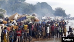 FILE - Burundian refugees gather on the shores of Lake Tanganyika in Kagunga village in Kigoma region in western Tanzania, as they wait for MV Liemba to transport them to Kigoma township, May 17, 2015. 