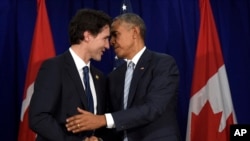 FILE - President Barack Obama (r) and Canada’s Prime Minister Justin Trudeau shake hands following their bilateral meeting at the Asia-Pacific Economic Cooperation summit in Manila, Philippines, Nov. 19, 2015.