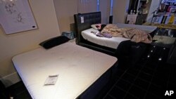 Dialina Gonzalez sleeps on a mattress inside a Gallery Furniture store which opened as a shelter Feb. 17, 2021, in Houston, Texas.