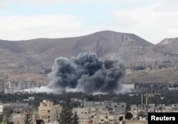 Smoke rises from besieged Eastern Ghouta in Damascus, Syria, Feb. 27, 2018.