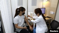 South Korean Olympic judo athlete receives the first dose of the Pfizer-BioNTech coronavirus vaccine at the National Medical Center in Seoul, April 29, 2021.