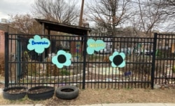 Signs welcome visitors to Girard Children's Community Garden in Washington, D.C.