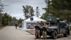 Rhode Island State Troopers and National Guard Officers work at a checkpoint, amid restrictions on travel due to the coronavirus disease (COVID-19) outbreak, at the Rhode Island Welcome Center in Richmond, Rhode Island, U.S., March 28, 2020. REUTERS/Olive