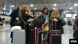 Preparing to board their train home, out-of-towners Sandy (second from right) and her friends are grateful they survived their unexpected adventures in New York. (VOA/A. Phillips)