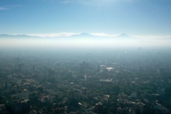 FILE - An aerial view shows low visibility due to air pollution during the COVID-19 pandemic, in Mexico City, Jan. 1, 2021.