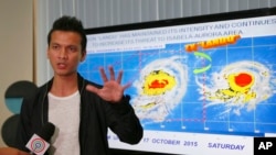 Weather Bureau forecaster Aldczar Aurelio gestures during a media briefing on Typhoon Koppu, Oct. 17, 2015 at suburban Quezon city, northeast of Manila, Philippines. 