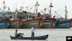 FILE - Vietnamese fishermen paddle their boat in Vung Tau, 125 kilometers (77 miles) southeast of Vietnam's Ho Chi Minh city.