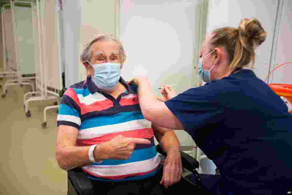 Henry (Jack) Vokes, 98, receives the Pfizer-BioNTech COVID-19 vaccine at Southmead Hospital, Bristol, England, Tuesday Dec. 8, 2020. The United Kingdom, one of the countries hardest hit by the…