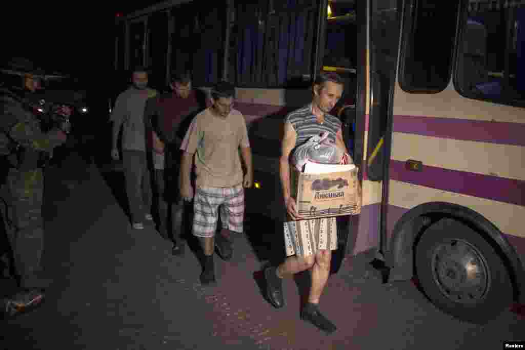 Members of the pro-Russian rebels, who are prisoners-of-war (POWs), walk along a road as they are being exchanged, north of Donetsk, eastern Ukraine, Sept. 12, 2014.&nbsp;