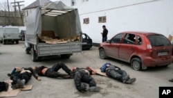 Bodies of four killed suspected militants are seen in Derbent region of Dagestan, April 18, 2011.