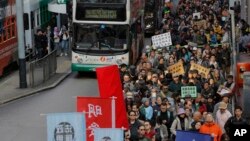 Hundreds of anti-government protesters march during an annual New Year protest in Hong Kong, Tuesday, Jan. 1, 2019. 