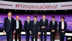 French politicians, from left to right, Arnaud Montebourg, Jean-Luc Bennahmias, Francois de Rugy, Benoit Hamon, Vincent Peillon, Manuel Valls and Sylvia Pinel, attend the first prime-time televised debate for the French left's presidential primaries in La Plaine Saint-Denis, near Paris, France, Jan.12, 2017.