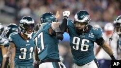 FILE - Philadelphia Eagles Malcolm Jenkins #27 celebrates with Derek Barnett #96 after a hit against New England Patriots Brandin Cooks at Super Bowl 52, February 4, 2018, in Minneapolis.
