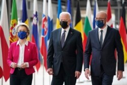 President Joe Biden, center, walks with European Council President Charles Michel, right, and European Commission President Ursula von der Leyen, during the United States-European Union Summit at the European Council in Brussels, June 15, 2021.