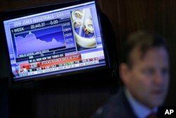 A TV displays financial information on the floor of the New York Stock Exchange in New York, Dec. 24, 2018.