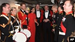 Britain's Prince Harry and Meghan, Duchess of Sussex, alongside the Massed Bands of Her Majesty's Royal Marines attend the Mountbatten Festival of Music at the Royal Albert Hall in London, March 7, 2020. 
