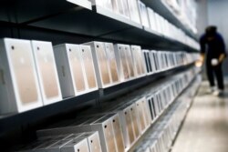 FILE - Apple's iPhone 7 smartphones sit on a shelf at an Apple store in Beijing, China, Sept. 16, 2016.