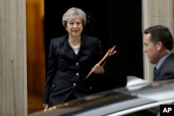 British Prime Minister Theresa May leaves 10 Downing Street to deliver a statement on Brexit to Parliament in London, Oct. 9, 2017.