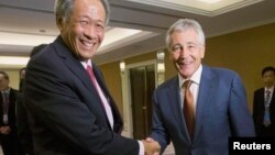 30일 싱가포르에서 개막한 아시아 안보회의에서 척 헤이글 미국 국방장관(오른족)이 응 엥 헨 싱가포르 국방장관과 악수하고 있다.