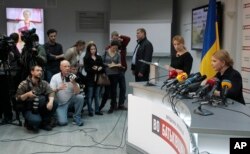 Former Ukrainian Prime Minister Yulia Tymoshenko, right, speaks during a news conference in Kyiv, Ukraine, April 1, 2014.