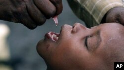 FILE -- In this Jan. 25, 2002 file photo, a Congolese child is given a polio vaccination at a relief camp near Gisenyi, Rwanda. 