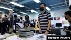 Staff members of Apple Daily work on their final edition in Hong Kong, July 21, 2021.