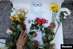 An attendee leaves flowers for Nabra Hassanen, a teenage Muslim girl killed by a bat-wielding motorist near a Virginia mosque, during a vigil in New York City, June 20, 2017.