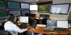 FILE - In this Feb. 12, 2013 file photo a member of the CTBTO staff works on the operation desk of the control room at Comprehensive Nuclear-Test-Ban Treaty Organization, CTBTO headquarters in Vienna, Austria.