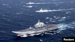 FILE - China's Liaoning aircraft carrier with accompanying fleet conducts a drill in an area of South China Sea, in this December 2016 photo.