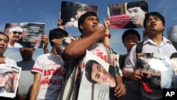 FILE - Supporters of 14 detained students protest outside the military court in Bangkok, Thailand, July 7, 2015.