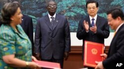 Chinese President Hu Jintao (2nd R) and Ghana's President John Atta Mills (2nd L) attend a signing ceremony after a welcoming ceremony at the Great Hall of the People, in Beijing, China, September 2010.