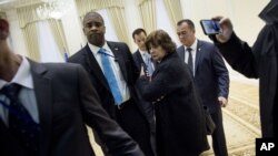 A US press pool reporter, woman at center, is escorted out after asking a question to Uzbek President Islam Karimov (not pictured) during a photo opportunity before a meeting with US Secretary of State John Kerry (not pictured) at the Palace of Forums on 
