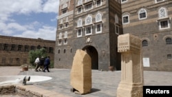 Museum staffers walk at the yard of the National Museum in Sanaa, Yemen June 2, 2021. (REUTERS/Khaled Abdullah)