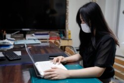 Han Shin Bi, a high school senior in Seoul, demonstrates how to take online classes after an interview in Seoul, South Korea, on Sept. 18, 2020. “Online classes were really inconvenient,” said Han. Experts say the reduced interaction with teachers, digita