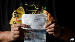 Alberto Herrera, 35, of Chicago shows his boarding pass and water-damaged passport a day after surviving the crash of Aeromexico flight 2431 just after takeoff, in Durango, capital of Durango state, Mexico, Aug. 1, 2018. 
