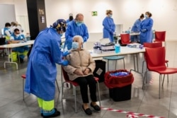 Madrid Emergency Service health workers conduct rapid antigen tests for COVID-19 in the southern neighborhood of Vallecas in Madrid, Spain, Oct. 2, 2020.