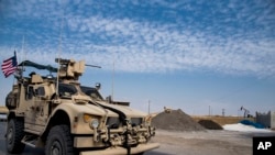 In this Oct. 28, 2019 photo, U.S. forces patrol Syrian oil fields. The Pentagon is increasing U.S. efforts to protect Syria's oil fields from the extremist group as well as from Syria itself and the country's Russian allies. 