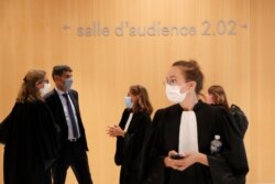 Lawyers and security officers arrive at the Paris courthouse for the second day of the 2015 attacks trial in Paris, France, Sept. 3, 2020.