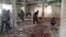 People examine the debris after a suicide bomb attack at the Imam Ali mosque in the village of al-Qadeeh in the eastern province of Gatif, Saudi Arabia, May 22, 2015.