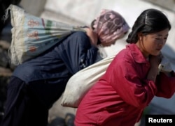 FILE - North Korean students and volunteers work to repair water supply system in Haeju, capital of the South Hwanghae province. (photos taken by Reuters during government-controlled tour)