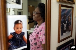 FILE - Gwen Strowbridge, 71, of Deerfield Beach, Florida, works six days a week caring for a 100-year-old woman. She has worked all her life and plans to work until she can't physically work anymore.