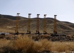 FILE - Equipment and machines are seen near a copper mine in Mes Aynak, Logar province, Feb. 14, 2015.