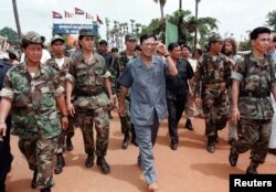 Cambodian Prime Minister Hun Sen, pictured here with his bodyguards in 1997, is one of the world’s longest serving leaders. REUTERS/Stringer
