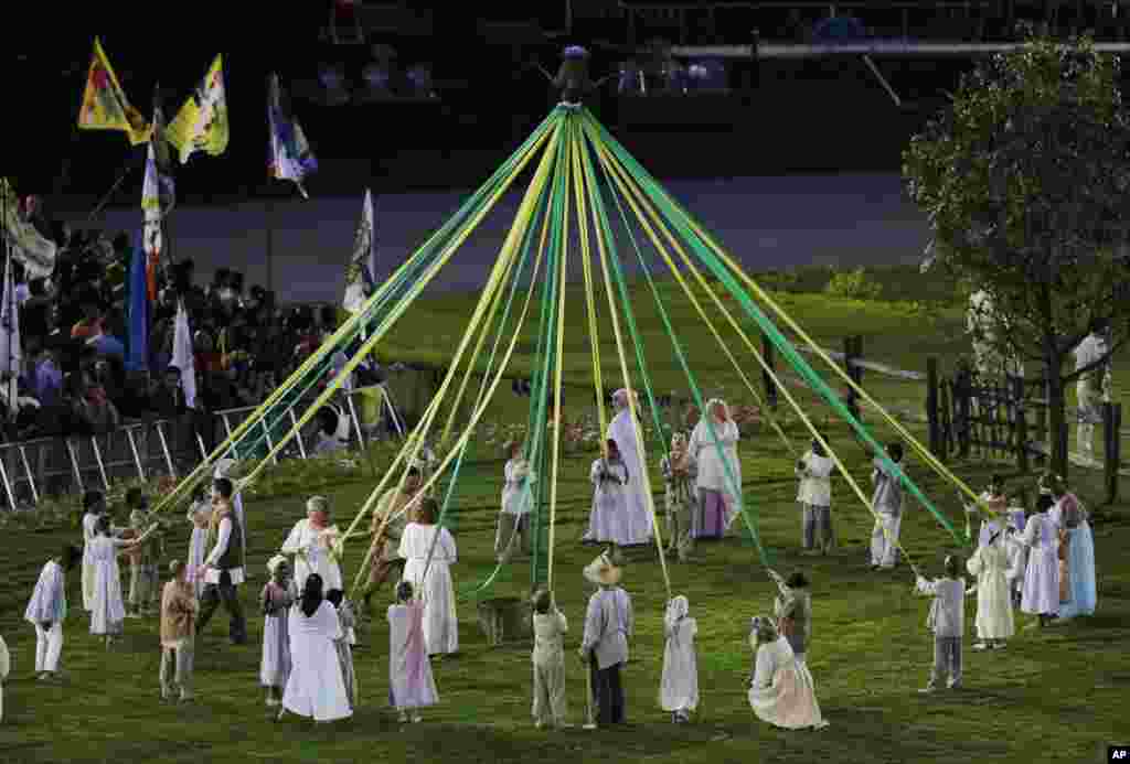 Performers make a circle during the Opening Ceremony at the 2012 Summer Olympics, July 27, 2012, in London.