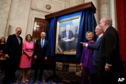 Senate Minority Leader Sen. Harry Reid, D-Nev., second from right, looks at a portrait of himself during a ceremony to honor his service in the Senate, on Capitol Hill, Dec. 8, 2016, in Washington.
