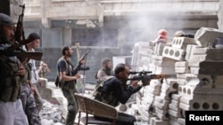 Members of the Free Syrian Army are seen at a front line in al-Mid area in Aleppo city in northern Syria, October 11, 2012. 