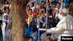 Pope Francis greets believers as he arrives for a mass in Dhaka, Bangladesh, Dec. 1, 2017.